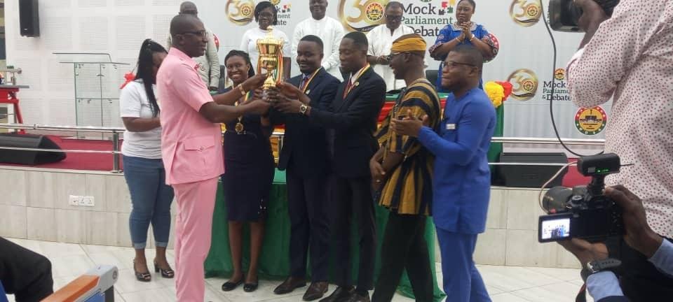 • Mr. Andrews Asiamah Amoako handind over trophy to KNUST team