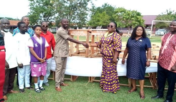• Mr. Annor Frimpong, President of the Group, in a group photograph with Madam Grace Asamani, the Headmistress of the school and others