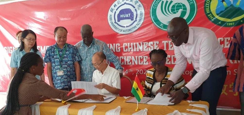 • Prof. Su Vibo and Mrs Cecelia Agyei Amoako signing the agreement. Looking on are officials of the two outfits
