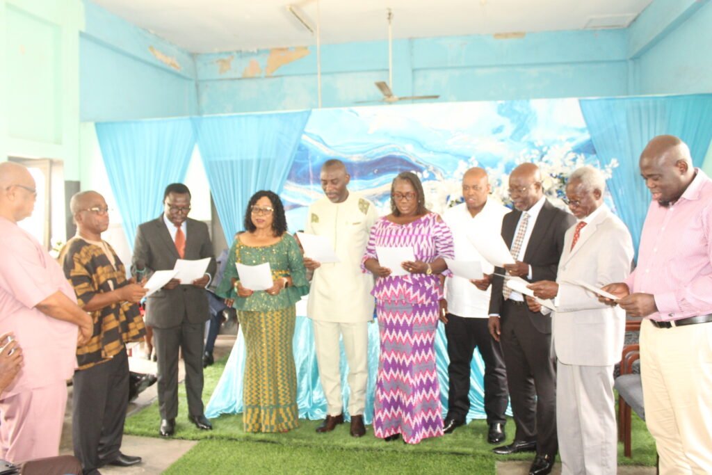 Mr Yaw Boadu Ayeboafo [2nd from left]swearing_in the members into office.