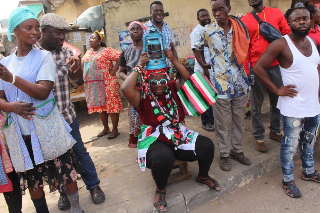 A resident of Adabraka making a case for 'dumsor' holding an old lantern