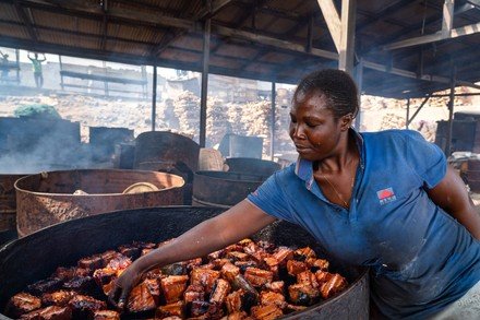 • A woman smoking fish the traditional way