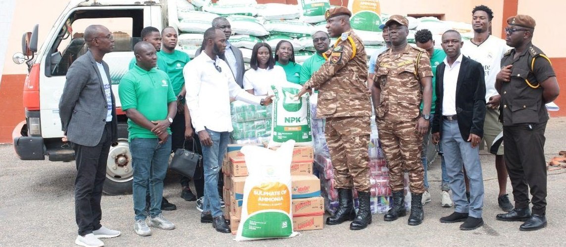 • Mr Ayittey (fourth right) presenting the items to officers of Ghana Prisons Service