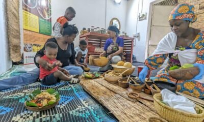 Madam Amina Pagnaa (right) dishing some traditional food to guests at the Duduhgu Traditional Kitchen