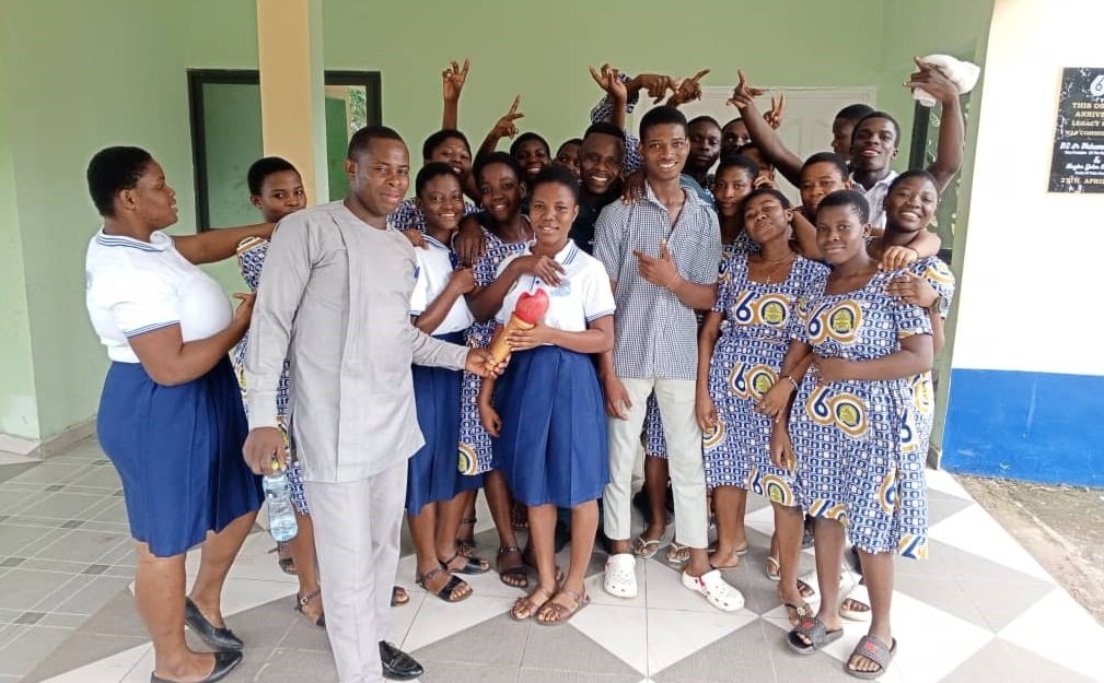 • Some final year students in a picture with an old student