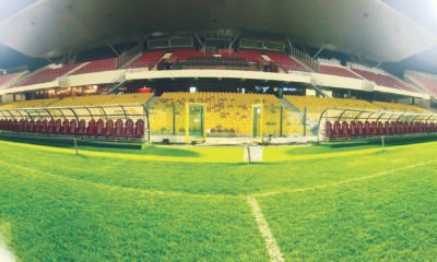 The green pitch with a new set of substitution benches