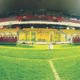 The green pitch with a new set of substitution benches