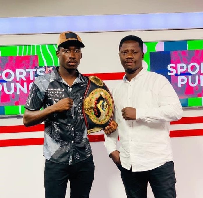 Coach Carl Lokko (right) and John Laryea display a title belt
