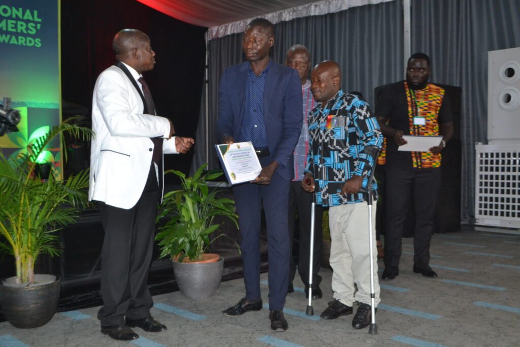 Mr. Simon Osei-Mensah (left), Ashanti Regional Minister presenting to Mr. Dominic Takyi Abeam, the Bono Regional Best Physically Chanllenged Farmer award Photo Victor A. Buxton