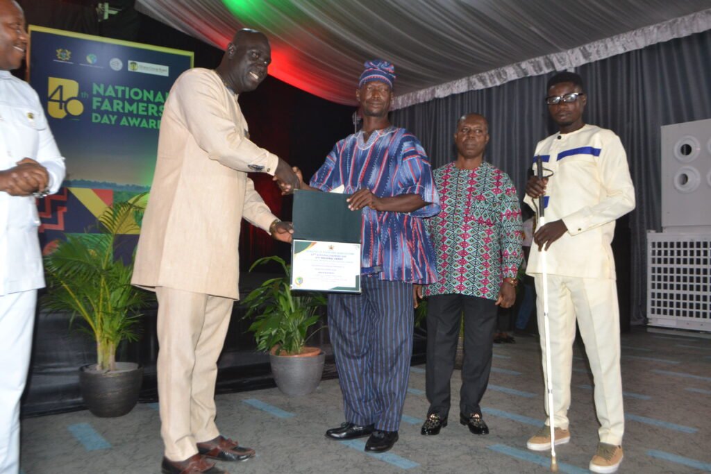 Mr. Mabanye Emmanuel (second from left) receiving the Oti Regional Best Physically Challenged Farmers Award Phoot Victor A. Buxton