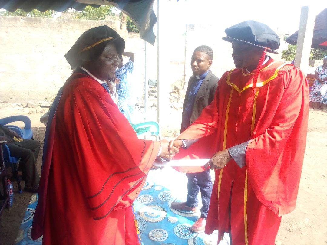 • Bishop Dr Fredrick Adjei presenting a certificate to Prophet Dr Mawuli Akorli.Looking on is Prophet Dr Joshua Abass Osumanu