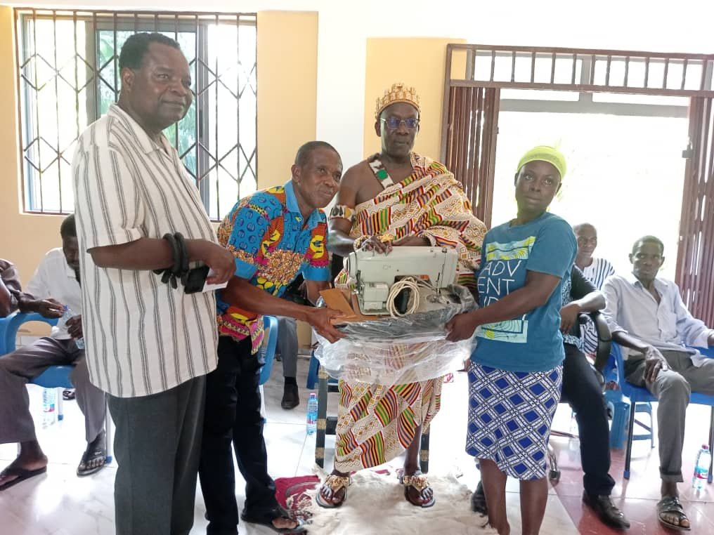 • Dr Ofori -Atta, (left) Nene Adjanor, (Second from right), and Sika receiving her sewing machine