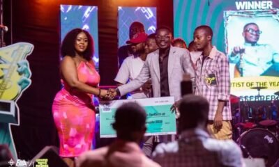 • Daasebre Kwame in suit recieving the award