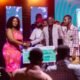 • Daasebre Kwame in suit recieving the award