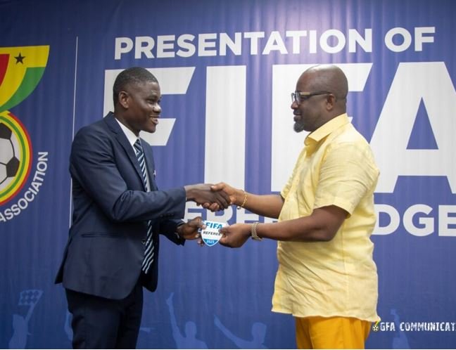 Ref Serlom Yao Bless (left) receiving his badge from FA President, Kurt Okraku