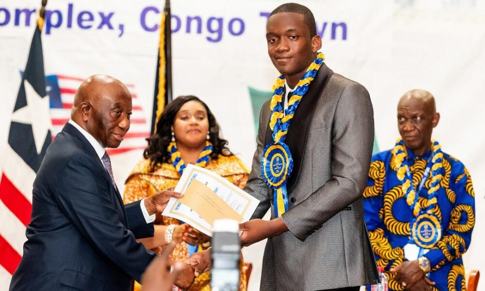 • President Bokai, Sr, presenting the overall best student award to David Ankrah of Hope College