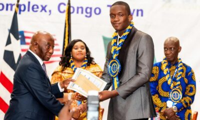 • President Bokai, Sr, presenting the overall best student award to David Ankrah of Hope College