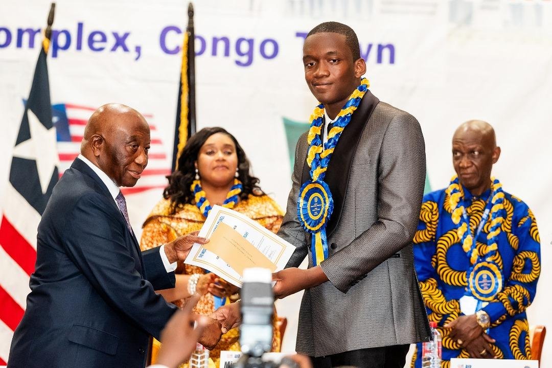 • President Bokai, Sr, presenting the overall best student award to David Ankrah of Hope College