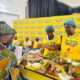 • One of the judges inspecting food cooked by participants