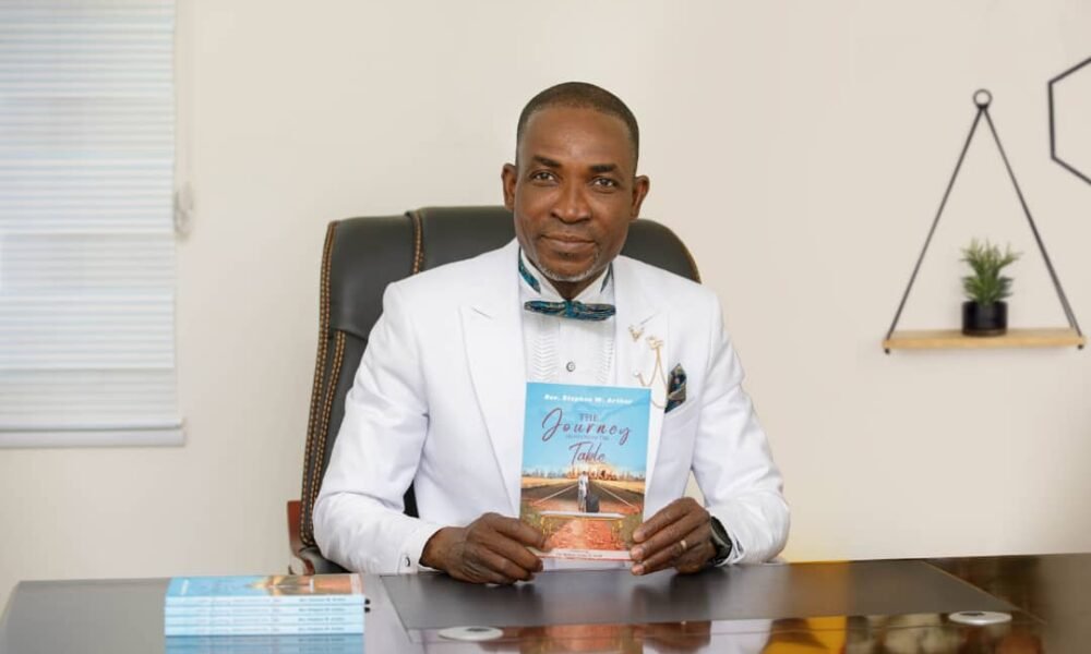 Rev. Stephen Arthur showcasing his book ‘The Journey From Under the Table’