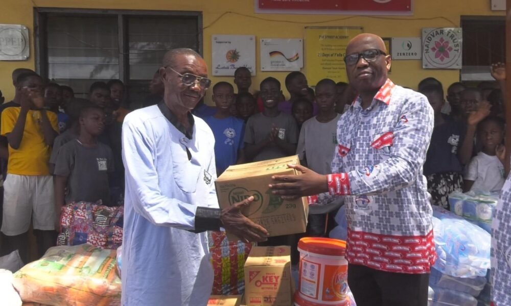 • Street Academy Director Ataa Lartey ( Left) receiving the items from Elder Peter Akorful, the Administrator of the Church