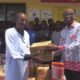 • Street Academy Director Ataa Lartey ( Left) receiving the items from Elder Peter Akorful, the Administrator of the Church