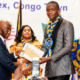 • President Bokai, Sr, presenting the overall best student award to David Ankrah of Hope College