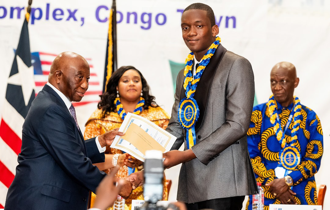 • President Bokai, Sr, presenting the overall best student award to David Ankrah of Hope College