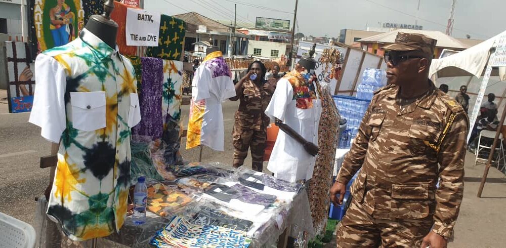 A prison officer inspecting a batik, tie and dye
