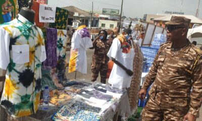 A prison officer inspecting a batik, tie and dye