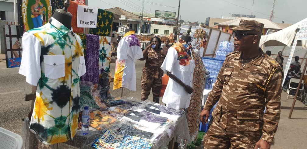 A prison officer inspecting a batik, tie and dye