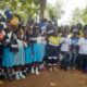 Mr Buta presenting a camera to one of the beneficiary schools