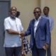 • Dr Ochan in a handsahke with Mr Adu Owusu after the meeting
