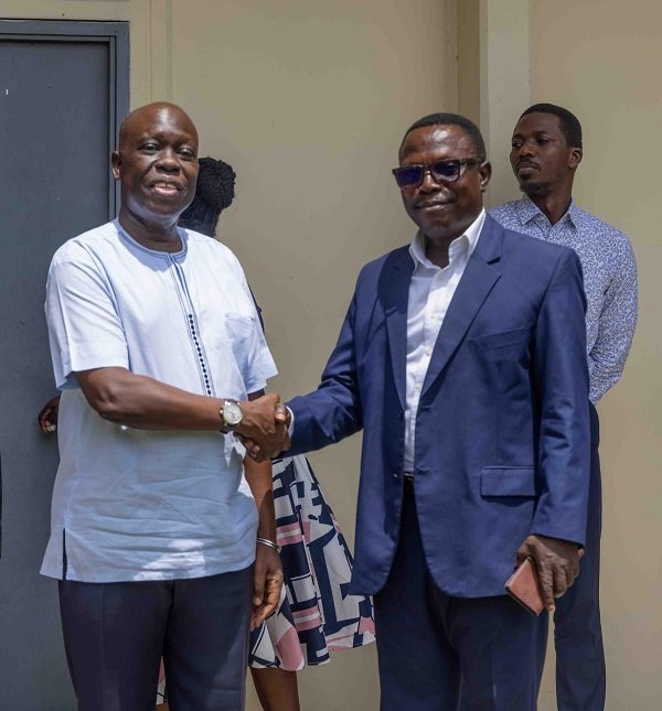 • Dr Ochan in a handsahke with Mr Adu Owusu after the meeting