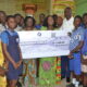 Ms Sowah (middle) handing over a dummy cheque to Mrs Kotomah (thrid from left). With them is Mr Alfredos Nii Anyetei (third from right) Photo: Victor A. Buxton