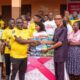 • Manager of Terry Yegbe, Eric Ahiabu (left) presenting sanitary products to a representative of Horti Primary School