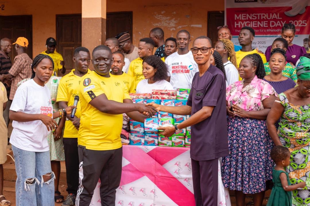 • Manager of Terry Yegbe, Eric Ahiabu (left) presenting sanitary products to a representative of Horti Primary School