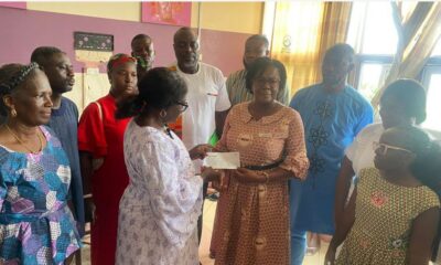 Madam Kwartey-Papafio(left) presenting the cheque to Madam Kyei (right)