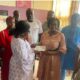 Madam Kwartey-Papafio(left) presenting the cheque to Madam Kyei (right)