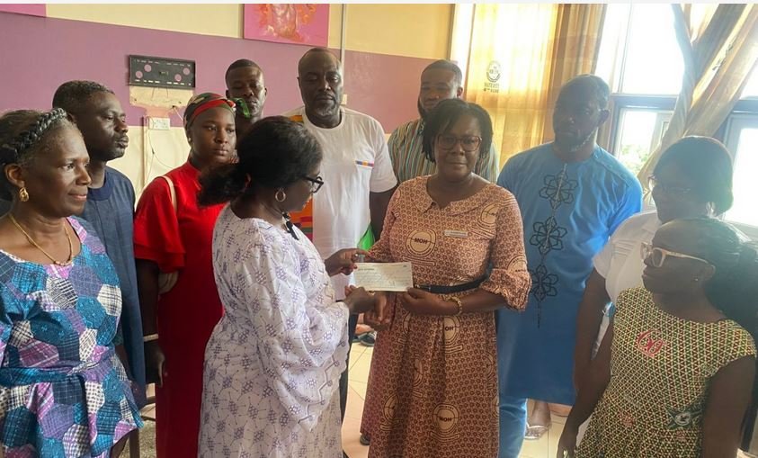 Madam Kwartey-Papafio(left) presenting the cheque to Madam Kyei (right)