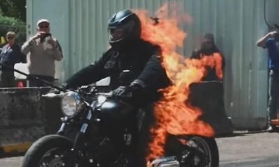 Man rideind motorcycle on fire