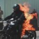 Man rideind motorcycle on fire