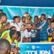 Hon. Dziwornu supported by some former Black Stars players to present the winner's trophy to Banabas FC