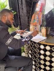 • General manager of Despite groups , Kennedy Osei signing the book of condolence
