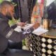 • General manager of Despite groups , Kennedy Osei signing the book of condolence