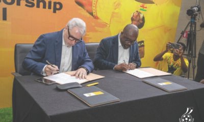 Mr Blewett (left) and Kurt Okraku append signatures to the deal