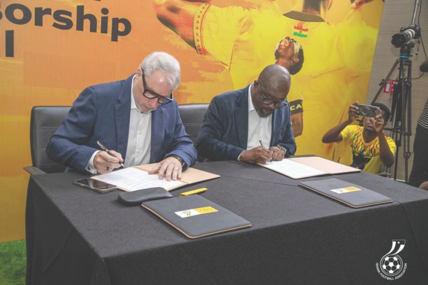 Mr Blewett (left) and Kurt Okraku append signatures to the deal