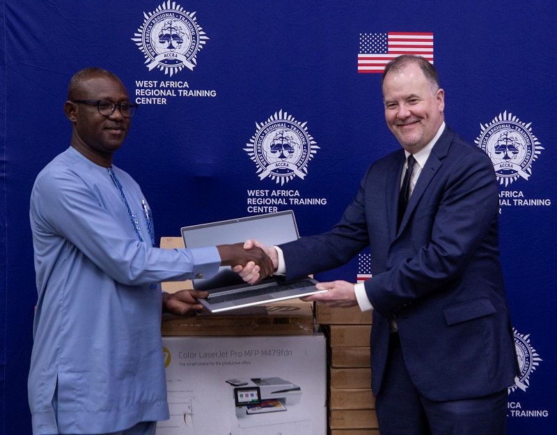 • Mr Charles Kipo (left) receiving the items from Mr Rolf Olson during the programme Photo: Victor A. Buxton