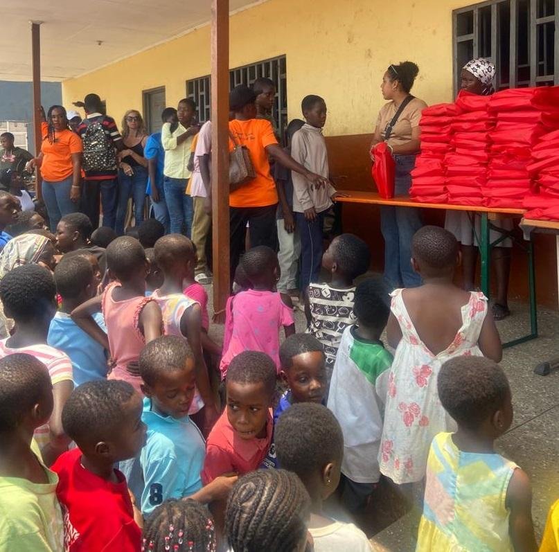 • A section of the children lines up to receive the books