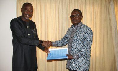 Mr Martin Adu-Owusu (right) handing over the document to Prof. Kwamena Kwansah -Aidoo